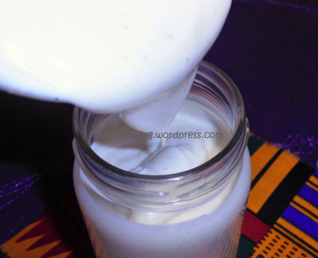 How to make mayonnaise at home; freshly made  mayonnaise being poured into a glass jar