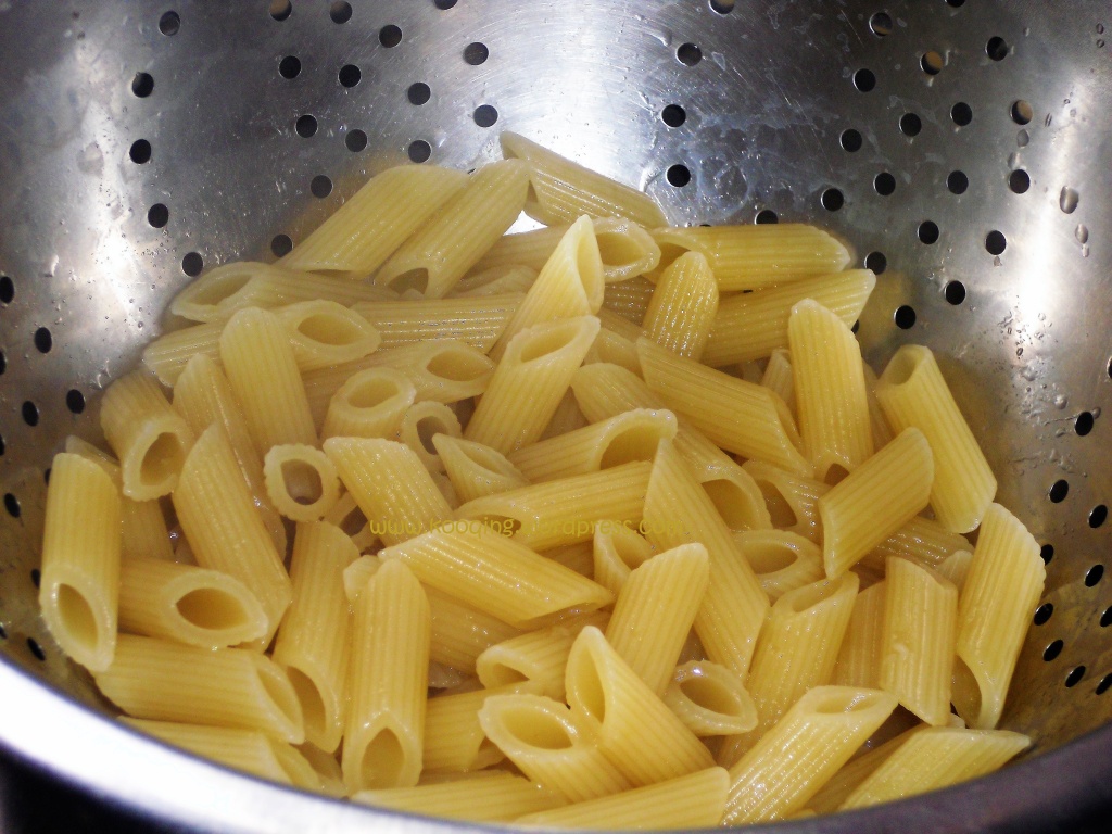 Penne with creamy tomato sauce recipe; A colander containing cooked and drained penne pasta